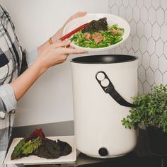 a woman holding a bowl with vegetables in it