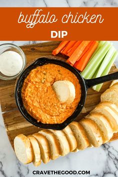 buffalo chicken dip in a cast iron skillet with carrots and celery