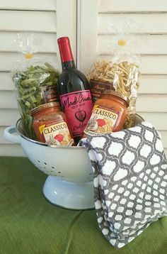 a white bowl filled with lots of food next to a bottle of wine and napkin