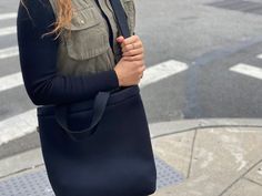 You are going to love our Town Bag! A chic, easy-to-wear crossbody perfect for carrying your daily essentials! Seriously tricked out with an inside slip pocket. It has a hearty snap at the top. Carry it by the handles or wear it as a crossbody for extra support. This is the perfect bag for everyday, on-the-go!Features: Zipper Compartment, Inner Slip Pocket, Snap Closure, Comfort Handles, Adjustable Crossbody Strap, 15" x 13" x 3".Details• Made in United States• Style: QK-TOWN-NBLACK Chic Everyday Bags With Cell Phone Pocket, Chic Everyday Bag With Cell Phone Pocket, Casual Satchel With Removable Pouch For On-the-go, Modern Medium Bags For Everyday Use, Everyday Functional Shoulder Bag For Fall, Modern Medium Everyday Bag, Modern Medium Everyday Bags, Casual Satchel With Removable Pouch, Everyday Black Satchel With Cell Phone Pocket