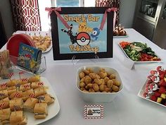 a table topped with lots of food and snacks