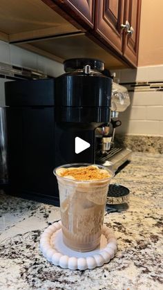 a cup of coffee sitting on top of a counter