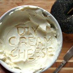 a close up of a cake in a white bowl on a wooden table with the words david's cream cheese written across it