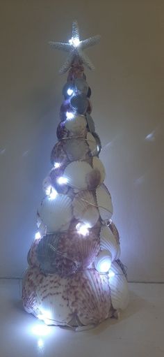 a christmas tree made out of seashells and lights