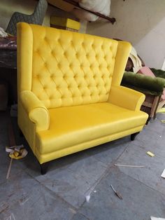 a yellow couch sitting on top of a floor