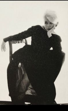 black and white photograph of a woman sitting on a chair