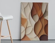 an abstract painting on the wall next to a white chair and wooden stools in a room