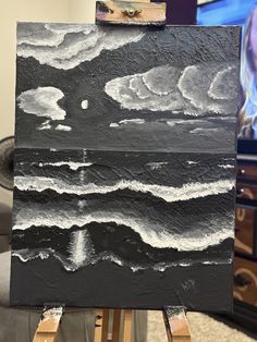 a black and white painting on an easel