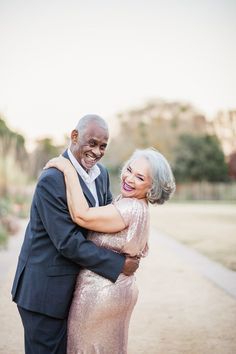 an older couple hugging each other on the street