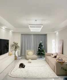 a living room filled with furniture and a christmas tree in the middle of the room