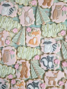 decorated cookies are arranged in rows on a table