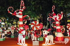 christmas decorations in the shape of candy canes on display at an outdoor market place