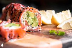 sushi rolls with avocado, cucumber and pepper on a cutting board