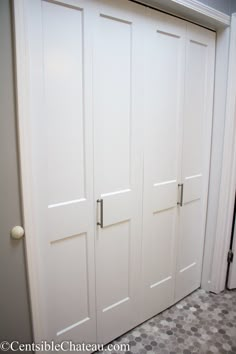 two white closet doors in a room with tile flooring