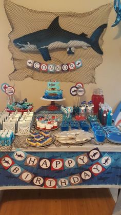 a shark themed birthday party with cake and decorations