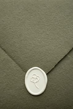 an envelope with a white button on it