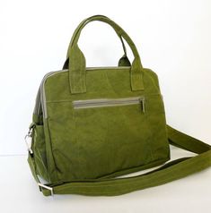 *** Please check 'shop announcement' for production time and delivery before your purchase. ***This bag is made from dark olive water resistant nylon, a sturdy and durable material. It is medium size bag but very roomy and big enough to hold lots of your essentials. You can use it as a everyday bag, messenger bag or travel bag.If you'd prefer this style in different colors, you can select colors from the chart in this listing. Or if you'd like to have this bag larger or smaller, I can do that wi Multi Pocket Bag, Overnight Travel Bag, Travel Bags For Women, Mk Bags, Handbags Tote, Leather Handbags Tote, Bag Light, Carry All Bag, Pocket Bag