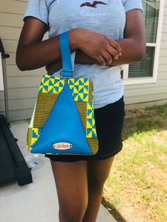 This handbag is cute and functional. It is handmade with rich African Kente design cotton print.  Size is small. Yellow Shoulder Bag With Zipper Pouch For Daily Use, Yellow Rectangular Shoulder Bag With Zipper Pouch, Blue Shoulder Bag With Zipper Pouch As Gift, Yellow Rectangular Shoulder Bag With Zipper, Yellow Bag With Removable Pouch For Personal Use, Yellow Shoulder Bag With Detachable Handle As Gift, Square Shoulder Bag With Zipper Pouch As Gift, Handmade Yellow School Bag, Yellow Rectangular Bucket Bag As Gift