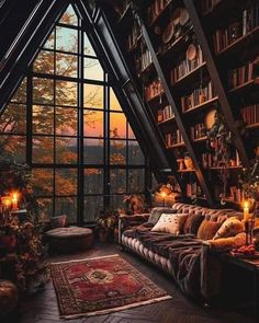 a living room filled with lots of books and furniture next to a tall book shelf