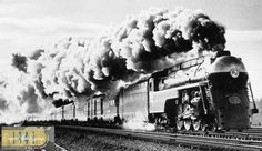 an old photo of a train blowing steam