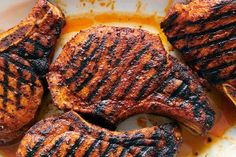 grilled steaks on a plate with sauce