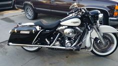 a black and white motorcycle parked next to a truck