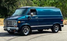 a blue van parked in a parking lot