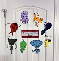 a door decorated with paper cut outs and an image of different types of cartoon characters