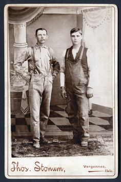 an old photo of two men standing next to each other