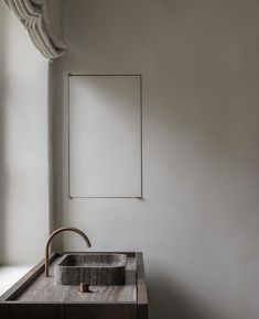 a bathroom sink sitting under a mirror next to a window