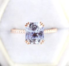 Stunning 5ct radiant cut pastel bluish lavender sapphire ring.  Details Main stone Gemstone: natural radiant cut lavender sapphire  Weight: 5ct 9.47*8.49mm Side stones: white diamonds half eternity: 18x 1.1mm diamonds Quality: clarity grade VS, color grade G, conflict-free Band width: approx 2 mm Material: 14/18k solid yellow/white/rose gold, platinum Sizes available: 3-8 (Larger and smaller sizes are available as well. Priced upon request.) Procedure information Please select the material and ring size from the drop-down menu on the right side of the listing. If you have any special requests or questions, please do not hesitate to contact us. Shipping information The item will be gift wrapped and shipped with insured express shipping from Europe. Senior Ring, Most Expensive Engagement Ring, Sapphire Engagement Ring Unique, Unique Sapphire Rings, Expensive Engagement Rings, Sapphire Side Stones, Pastel Lavender