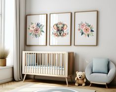 a baby's room with three framed pictures on the wall and a teddy bear