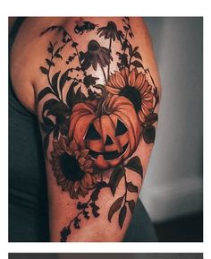 a woman's arm with sunflowers and a pumpkin tattoo on her shoulder