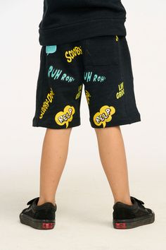 Let your son be the coolest kid on the block in these one-of-a-kind Scooby Doo shorts! The linen French jersey fabric and stylish Shadow Black color are already a win, but the front and back graphics of Scooby and his cool catchphrases are the icing on the cake! Complete the look with a matching top and sneakers and he'll be groovin' all day long. Model is wearing a size 6T Fabric Content: 50% Cotton 50% Modal Imported Style: CB1217-SCY006-SHDW Hip Hop Bottoms With Letter Print For Summer, Hip Hop Summer Bottoms With Letter Print, Hip Hop Graphic Print Bottoms For Summer, Graphic Print Hip Hop Bottoms For Summer, Hip Hop Style Graphic Print Bottoms For Summer, Summer Casual Bottoms With Cartoon Print, Hip Hop Style Relaxed Fit Summer Shorts, Black Cotton Bottoms With Graffiti Print, Trendy Graphic Print Cotton Bottoms