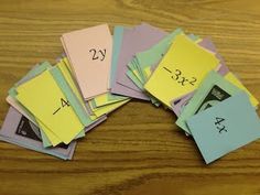 a pile of sticky notes sitting on top of a wooden table