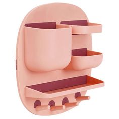 a pink wall mounted shelf with two cups on it