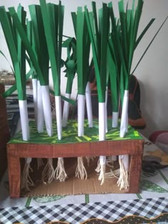 there are many white and green toothpicks on the table with grass in them