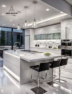 a modern kitchen with white marble counter tops and black bar stools in the center