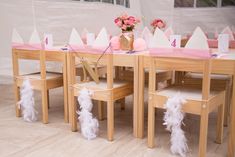 a table set up with pink and white decorations for a princess birthday or baby shower