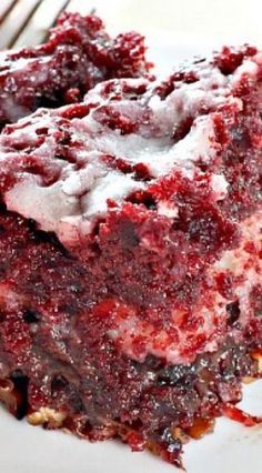 a close up of a piece of cake on a plate with icing and crumbs