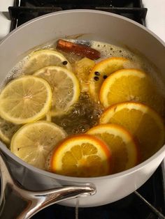 lemons are being cooked in a pot on the stove top with hot water and spices