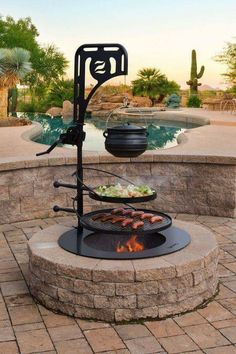 an outdoor bbq grill with food cooking on it in front of a swimming pool