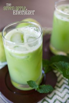 the green apple energizer is served in glasses with mint garnish