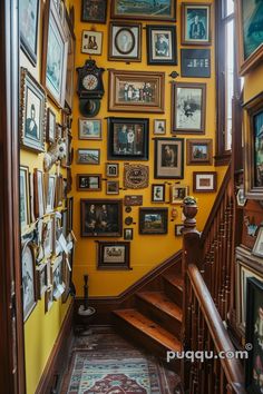 a staircase with many framed pictures on the wall