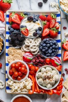 a platter filled with fruit, pretzels and other snacks