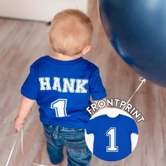 Personalized Birthday Number Shirt 1st Birthday Boy Tee Any Number and Name Kids Birthday Custom Shirt Baby Boy First Birthday Outfit Personalized  1st Birthday shirt with a name and age of your child. Cute for boys 1st birthday party shirt. Can be customized for any age or birthday. Choose a color of a t-shirt, color of the design and make it yours!  Two sides of the t shirt are personalized for your child. ⭐️ 𝐇𝐨𝐰 𝐭𝐨 𝐨𝐫𝐝𝐞𝐫: Please specify : Name: Number: Print Color: Font chart is ava Blue Short Sleeve T-shirt For First Birthday, Blue Crew Neck T-shirt For First Birthday, Blue Family Matching Shirt For Birthday, Family Matching Blue Shirt For Birthday, Customizable Blue T-shirt For First Birthday, Personalized Blue T-shirt For Birthday, Baby Boy First Birthday Outfit, Font Chart, 1st Birthday Boy