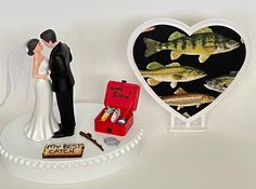 a bride and groom standing next to each other in front of a heart shaped box