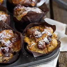 some desserts are sitting on a plate with powdered sugar and chocolate in them