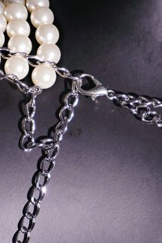 This pearl shoulder chain combines classic pearls with a trendy chain design, creating a unique and captivating accessory that exudes timeless elegance. Crafted with lustrous pearls, this shoulder chain not only adds a touch of sophistication to your ensemble but also enhances your natural allure. Let the delicate pearls enhance your beauty and radiate charm wherever you go. Whether it's a formal event, a romantic dinner, or a night out with friends, this pearl chain shoulder necklace is the per Silver Pearl Necklace With Chain, Elegant Double Chain Belt For Evening, Party Metal Chain Necklace With Pearl Chain, Elegant Double Chain Body Chain For Party, Silver Pearl Chain Necklace For Party, Elegant Beaded Chain Metal Necklace, Chic Pearl Chain Necklace With Adjustable Chain, Elegant Metal Body Chain With Beaded Detail, Pearl White Metal Pearl Necklace For Party