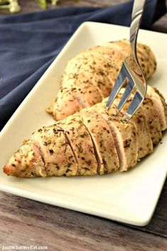 a piece of chicken being cut with a fork